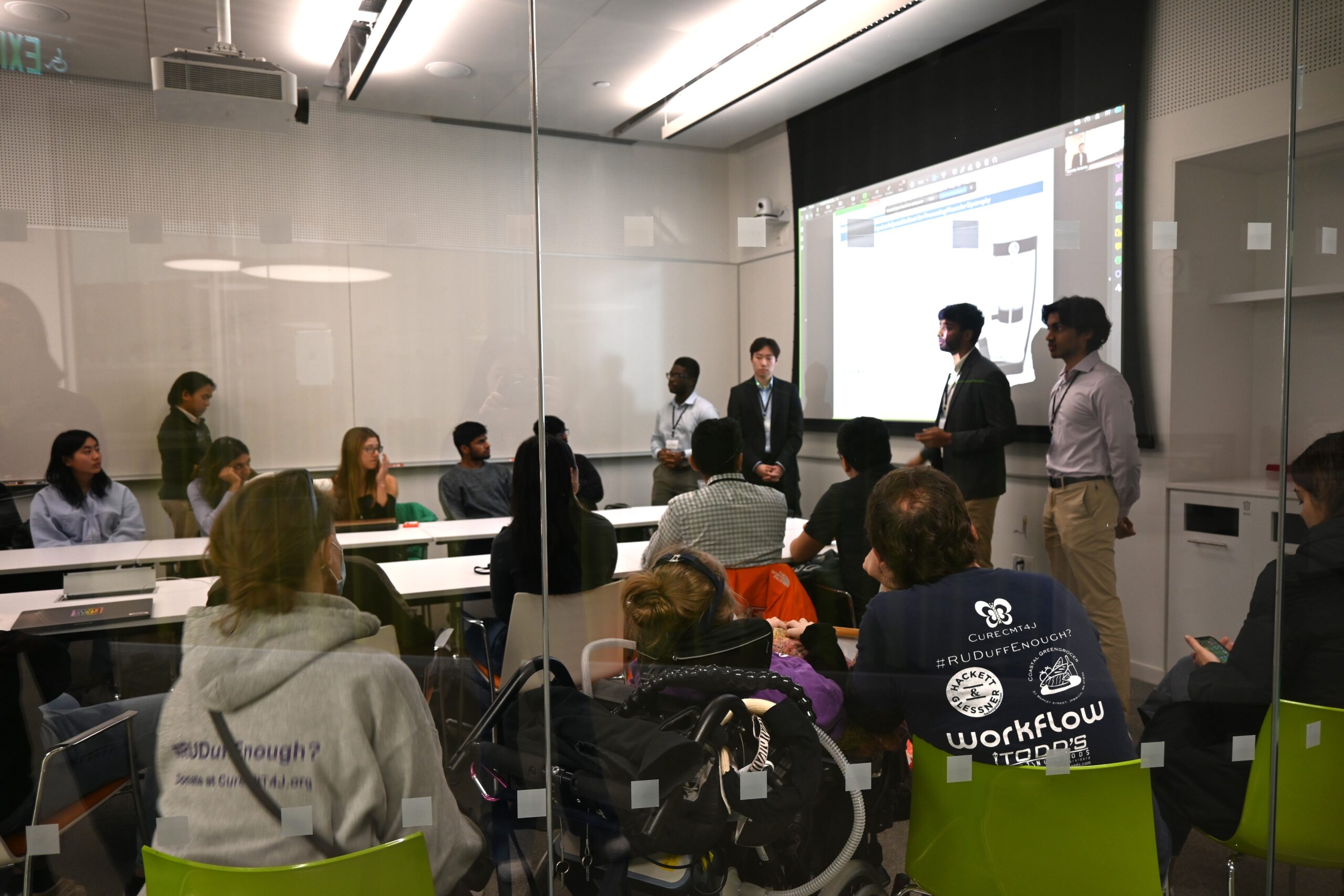 The team presenting their CMT4J pressure-reducing customizable boot at the Harvard Hackathon to an audience that includes CMT patients.